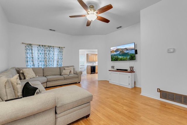 living room with ceiling fan and light wood-type flooring