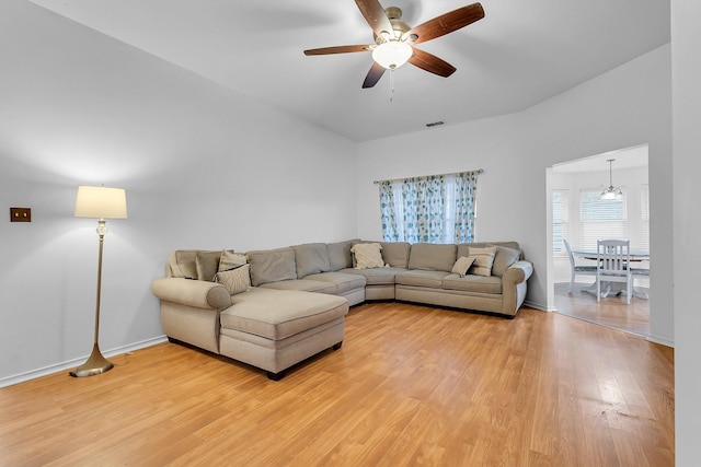 living room with hardwood / wood-style flooring and ceiling fan