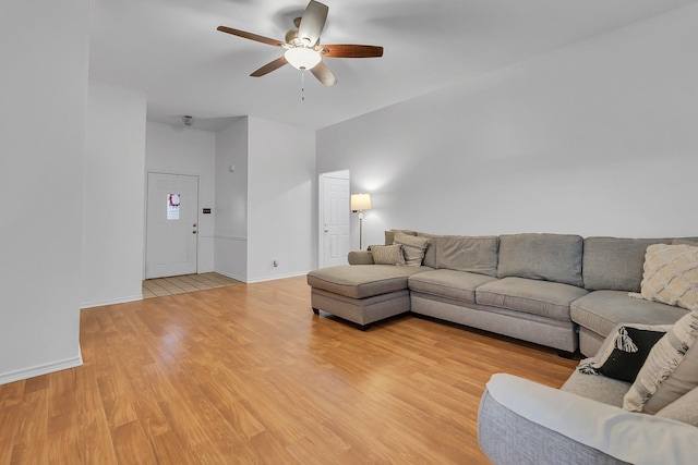 living room featuring light hardwood / wood-style flooring and ceiling fan