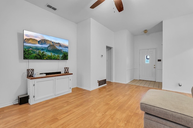 living room with light hardwood / wood-style floors and ceiling fan