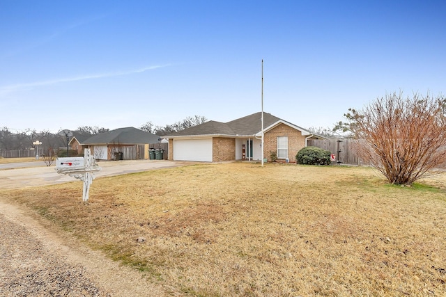 ranch-style house with a garage and a front lawn