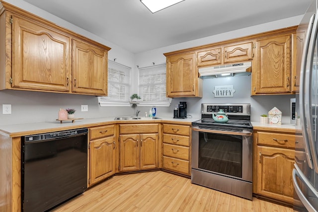 kitchen featuring stainless steel appliances, light hardwood / wood-style floors, and sink