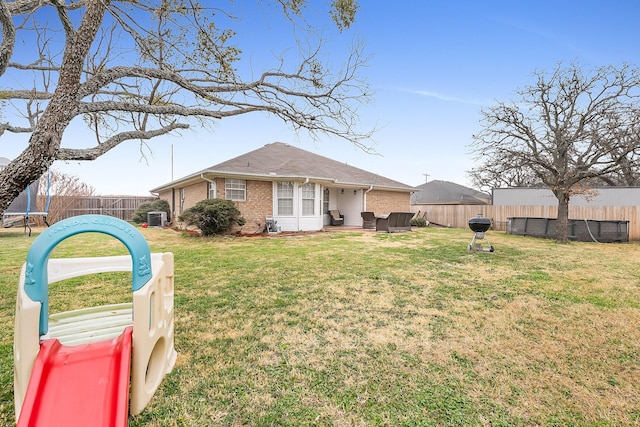 exterior space with a front yard and a trampoline