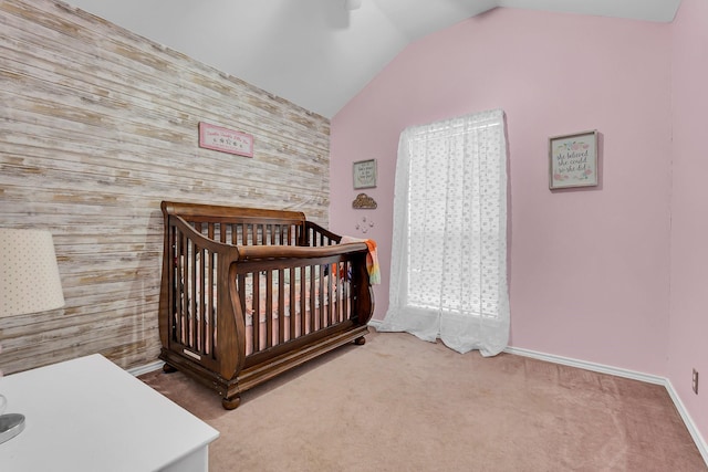 bedroom featuring ceiling fan, lofted ceiling, carpet floors, and a crib