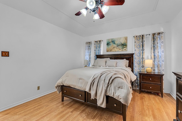 bedroom with ceiling fan and light hardwood / wood-style floors