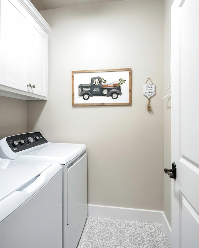 clothes washing area featuring cabinets, washing machine and clothes dryer, and light tile patterned floors