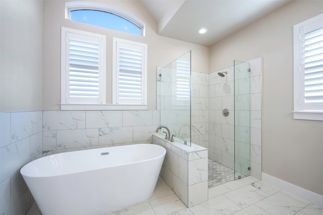 bathroom with shower with separate bathtub