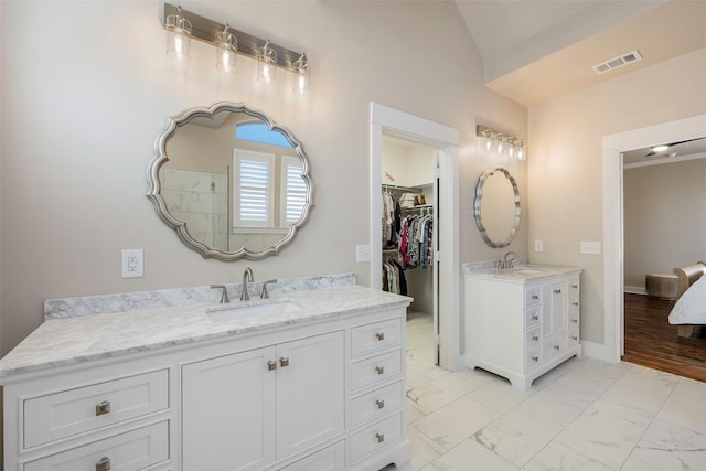 bathroom featuring vanity and lofted ceiling