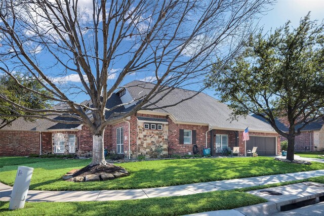 view of front of property featuring a garage and a front yard