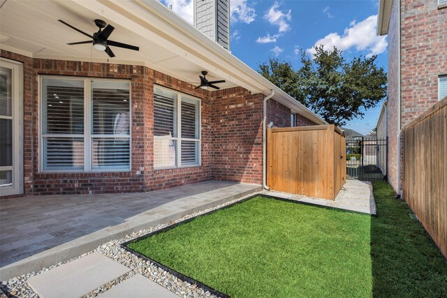 entrance to property featuring ceiling fan and a patio area