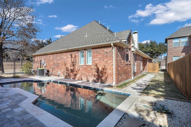 exterior space featuring a fenced in pool, a patio, and central air condition unit