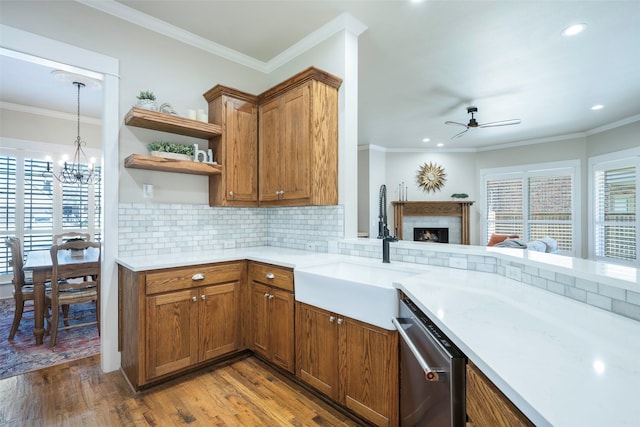 kitchen with crown molding, stainless steel dishwasher, plenty of natural light, and sink