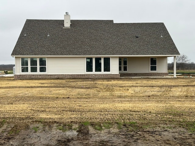 rear view of house with a lawn