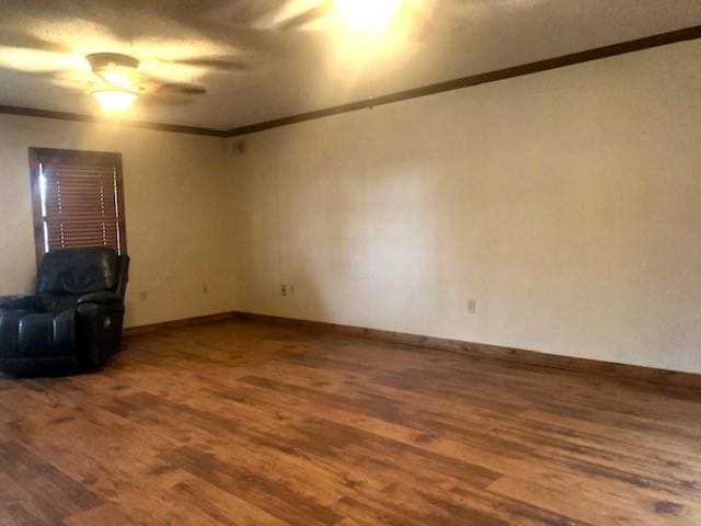 unfurnished living room with hardwood / wood-style floors and ornamental molding