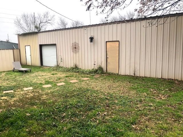 view of outbuilding featuring a yard