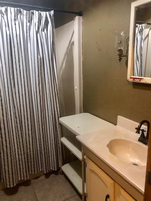 bathroom with a shower with curtain, vanity, and tile patterned flooring