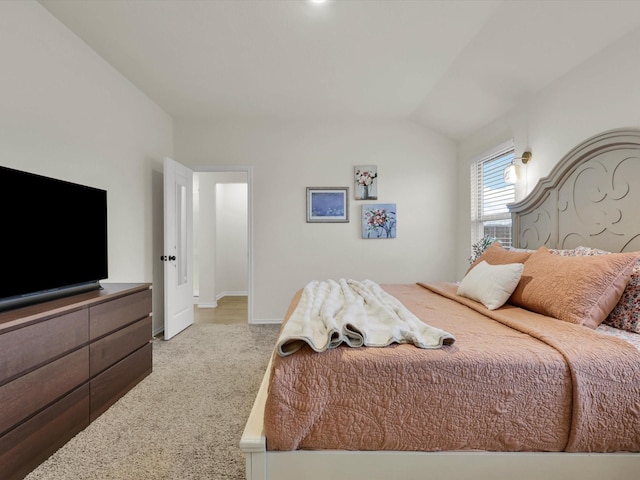 carpeted bedroom with lofted ceiling