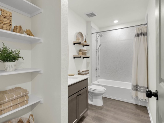 full bathroom with toilet, vanity, shower / bathtub combination with curtain, and hardwood / wood-style floors