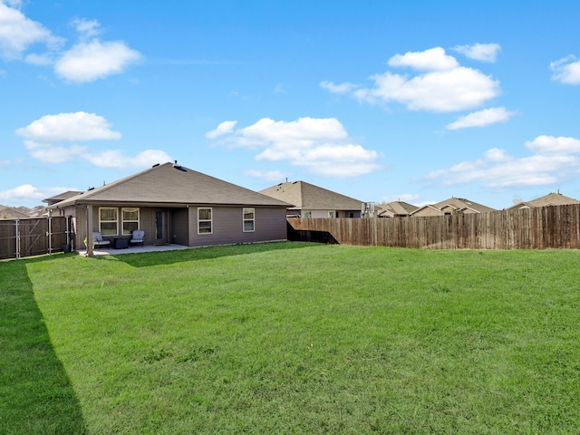 back of property featuring a patio area and a lawn