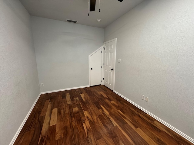 empty room with dark hardwood / wood-style floors and ceiling fan