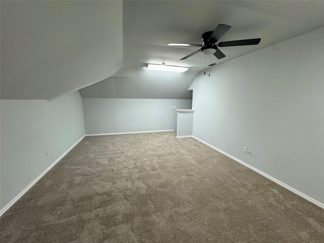 bonus room featuring vaulted ceiling, carpet, and ceiling fan