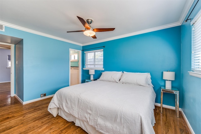 bedroom featuring hardwood / wood-style flooring, ornamental molding, and ceiling fan