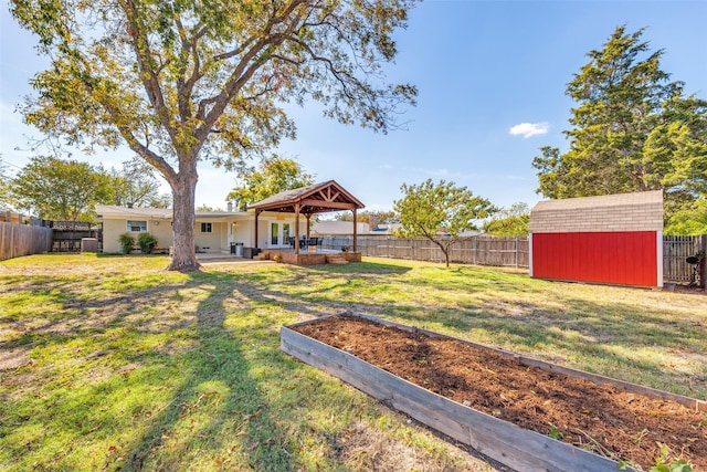 view of yard with a gazebo and a storage unit