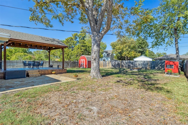 view of yard with a shed and a patio area