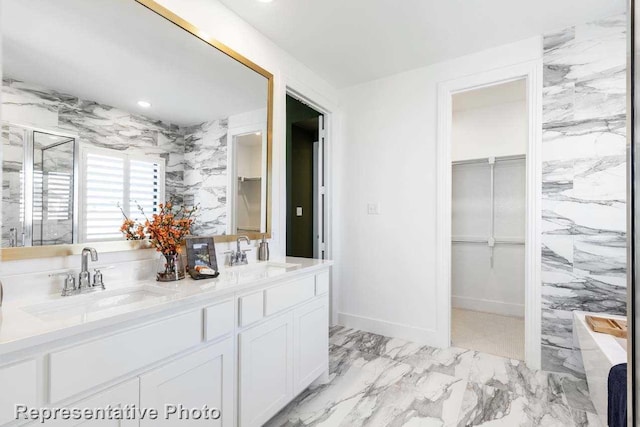 bathroom with vanity and tile walls