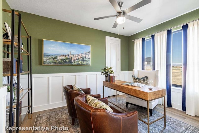 office with hardwood / wood-style flooring and ceiling fan