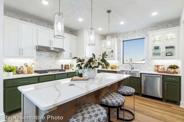 kitchen featuring a kitchen island, sink, white cabinets, green cabinets, and stainless steel appliances