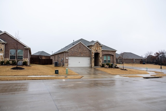 view of front of house featuring central AC unit and a garage