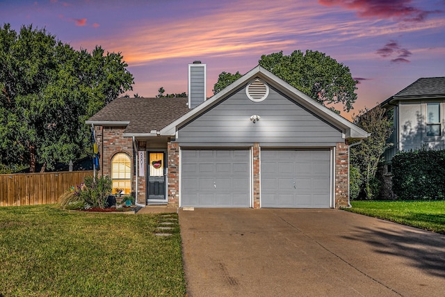 view of front of home featuring a garage and a lawn