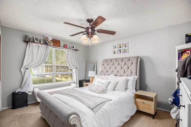 bedroom with a textured ceiling, light colored carpet, and ceiling fan