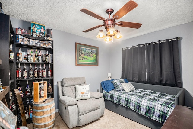 bedroom featuring ceiling fan, carpet flooring, bar, and a textured ceiling