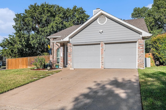 ranch-style home featuring a garage and a front lawn