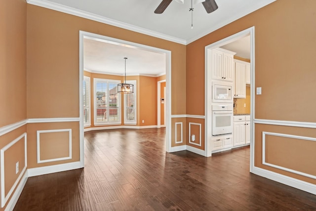 empty room with ornamental molding, dark wood-type flooring, and ceiling fan with notable chandelier