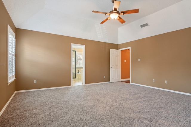 carpeted empty room featuring vaulted ceiling and ceiling fan