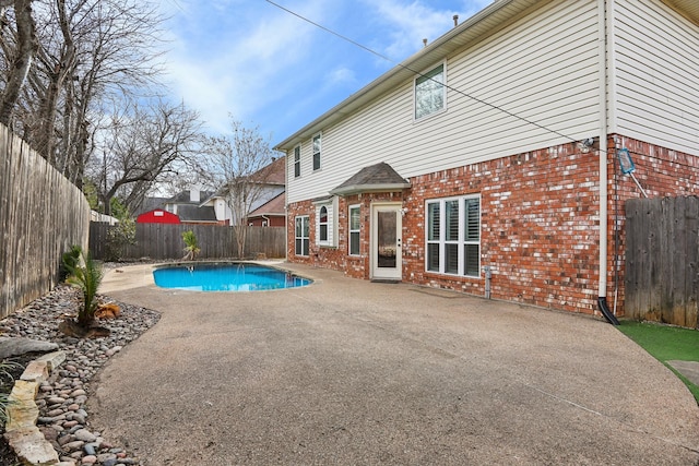 view of swimming pool with a patio area, a fenced backyard, and a fenced in pool