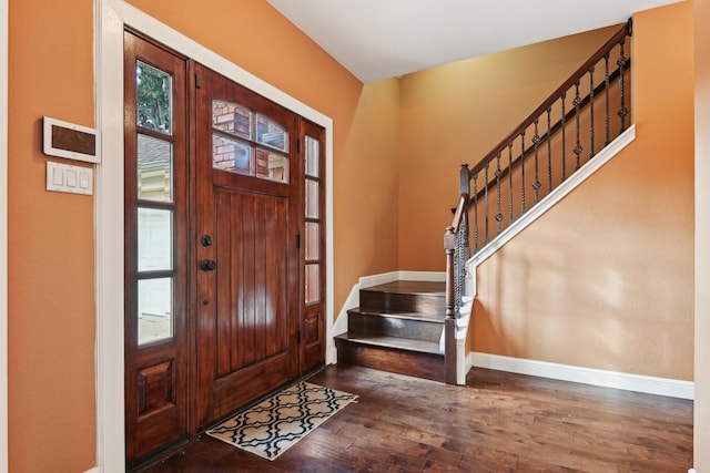 entrance foyer featuring stairs, wood finished floors, and baseboards