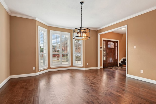 unfurnished dining area with an inviting chandelier, crown molding, and dark hardwood / wood-style floors