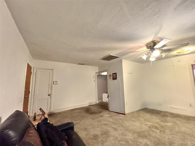 unfurnished living room with ceiling fan, carpet, and a textured ceiling