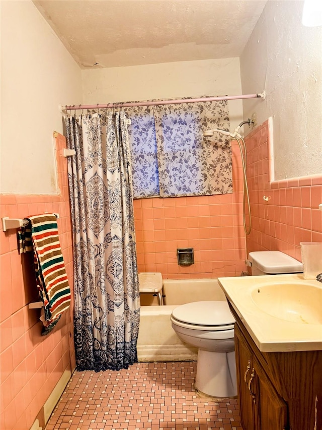 full bathroom with tile walls, shower / tub combo, vanity, tile patterned floors, and toilet