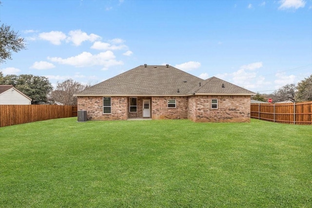 rear view of property featuring a lawn