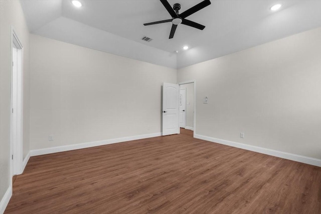 empty room featuring vaulted ceiling, ceiling fan, and dark hardwood / wood-style flooring