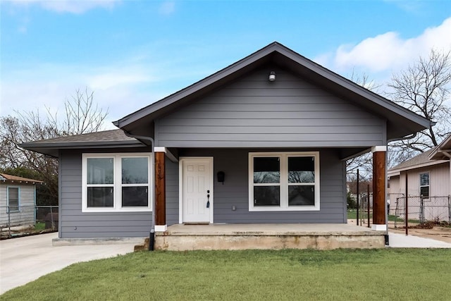 bungalow-style house featuring a porch and a front yard