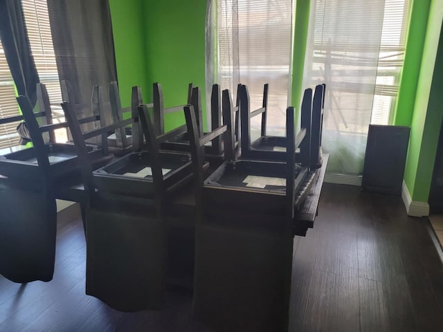 workout area featuring dark wood-style floors and baseboards