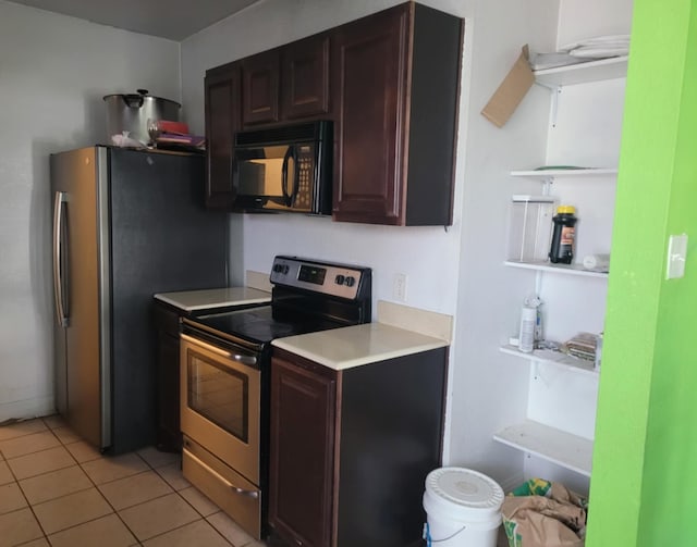 kitchen with light tile patterned floors, appliances with stainless steel finishes, light countertops, and dark brown cabinets