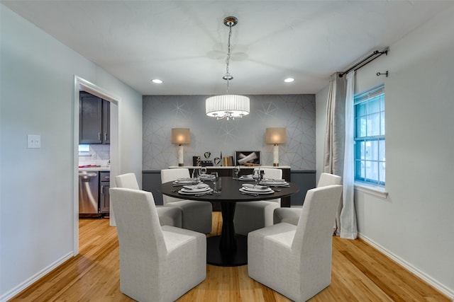 dining room with a notable chandelier and light hardwood / wood-style floors