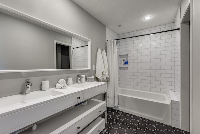 bathroom with tile patterned flooring, shower / bath combo, and vanity